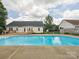 View of backyard pool and exterior of home with deck and back door at 116 Birchwood Ct, Mount Holly, NC 28120