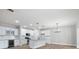 A stylish kitchen boasts granite countertops, white cabinets, stainless steel appliances, and modern lighting at 12526 Susanna Dr, Charlotte, NC 28214