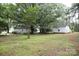 The home features a spacious yard with mature trees, providing privacy and shade at 1270 N Enochville Ave, China Grove, NC 28023