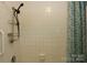 Bathroom shower with white tile and a patterned curtain at 1270 N Enochville Ave, China Grove, NC 28023