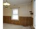 Sunlit bedroom with classic wallpaper and wood trim at 1270 N Enochville Ave, China Grove, NC 28023
