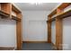 Spacious walk-in closet with wooden shelving units on both sides at 1270 N Enochville Ave, China Grove, NC 28023