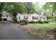 Charming single-story home featuring red shutters, mature trees, and an adjacent detached garage at 1270 N Enochville Ave, China Grove, NC 28023
