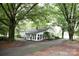 Picturesque setting featuring a home addition with a sunroom, surrounded by mature shade trees at 1270 N Enochville Ave, China Grove, NC 28023