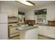 Bright kitchen featuring white cabinets, an island, and vintage appliances at 1270 N Enochville Ave, China Grove, NC 28023