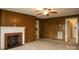 Living room with wood paneling and fireplace with brick surround at 1270 N Enochville Ave, China Grove, NC 28023