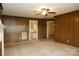 Living room with wood-paneled walls and access to an adjacent bathroom at 1270 N Enochville Ave, China Grove, NC 28023