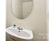 Compact half-bathroom includes modern faucet and mirror at 14018 Drake Watch Ln, Charlotte, NC 28262