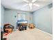 Bedoom with ceiling fan, blue walls, and window providing natural light at 14018 Drake Watch Ln, Charlotte, NC 28262