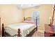 Bedroom with a window and a bed with an ornate iron headboard at 14018 Drake Watch Ln, Charlotte, NC 28262