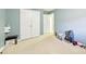 Spacious bedroom with carpet, white trim and blue accent wall with double closets at 14018 Drake Watch Ln, Charlotte, NC 28262