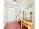 Bright foyer with hardwood floors, staircase, and elegant decorative accents at 14018 Drake Watch Ln, Charlotte, NC 28262