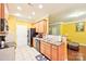 Bright eat-in kitchen has wood cabinets, black appliances, and a tile backsplash at 14018 Drake Watch Ln, Charlotte, NC 28262