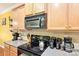 Kitchen features wooden cabinets, black appliances, and tiled backsplash at 14018 Drake Watch Ln, Charlotte, NC 28262