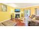 Cozy living room featuring a fireplace, hardwood floors, and comfortable seating at 14018 Drake Watch Ln, Charlotte, NC 28262