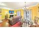 Open-concept living room flowing into the dining area, with hardwood floors at 14018 Drake Watch Ln, Charlotte, NC 28262