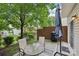 Outdoor patio with a table, chairs, grill and an umbrella perfect for entertaining guests or relaxing alone at 14018 Drake Watch Ln, Charlotte, NC 28262
