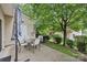 Back patio with seating, lush greenery and shady trees at 14018 Drake Watch Ln, Charlotte, NC 28262