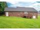 Expansive backyard view highlighting the brick home, raised deck and surrounding greenery at 1483 Dawnview Ln, Lincolnton, NC 28092