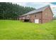 Expansive backyard featuring a brick home with a deck and a lush green lawn and mature trees at 1483 Dawnview Ln, Lincolnton, NC 28092