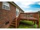 Backyard featuring a raised wood deck and brick facade providing views of the grassy space at 1483 Dawnview Ln, Lincolnton, NC 28092