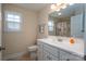 Neat bathroom featuring white cabinets and a large mirror at 1483 Dawnview Ln, Lincolnton, NC 28092