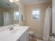 Clean bathroom features white vanity and a shower with white curtain at 1483 Dawnview Ln, Lincolnton, NC 28092