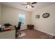 Bright bedroom featuring a ceiling fan, neutral walls, and a work desk near a window at 1483 Dawnview Ln, Lincolnton, NC 28092