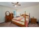 Cozy bedroom features a ceiling fan and a large window providing natural light at 1483 Dawnview Ln, Lincolnton, NC 28092