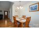 Dining room with wood table, chairs, chandelier, hardwood floors, and wall art at 1483 Dawnview Ln, Lincolnton, NC 28092