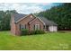 Well-maintained brick home with a charming front porch, lush landscaping, and a manicured lawn at 1483 Dawnview Ln, Lincolnton, NC 28092