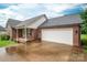 Charming brick home with an attached garage, a cozy porch, and a well-maintained driveway at 1483 Dawnview Ln, Lincolnton, NC 28092