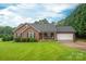 Inviting single-story brick home with a well-maintained lawn, and attached two car garage at 1483 Dawnview Ln, Lincolnton, NC 28092