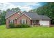 Charming brick home with lush lawn, two-car garage, and a manicured front yard at 1483 Dawnview Ln, Lincolnton, NC 28092