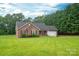 Beautiful brick home with a well-manicured lawn and mature trees, showcasing its curb appeal at 1483 Dawnview Ln, Lincolnton, NC 28092