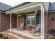 Cozy front porch with chairs and decorations, set on a brick home with a welcoming entrance at 1483 Dawnview Ln, Lincolnton, NC 28092