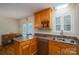 Kitchen area with wood cabinets, stainless steel dishwasher, and double sink under window at 1483 Dawnview Ln, Lincolnton, NC 28092