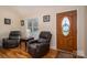 Living room features hardwood floors, a window, and a wooden front door at 1483 Dawnview Ln, Lincolnton, NC 28092