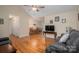Living room showcasing hardwood floors, a large TV, and a view into the dining area at 1483 Dawnview Ln, Lincolnton, NC 28092