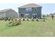 Large backyard with lush green grass, patio seating, and landscaping, perfect for outdoor enjoyment at 151 Outrigger Ln, Troutman, NC 28166