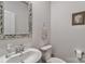 Powder room with a pedestal sink, decorative mirror, and modern toilet at 151 Outrigger Ln, Troutman, NC 28166