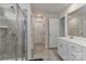Bright bathroom with a glass-enclosed shower, tiled floors, and a modern vanity with double sinks at 151 Outrigger Ln, Troutman, NC 28166