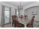 Formal dining room with a large table, elegant chairs, and natural light from nearby windows at 151 Outrigger Ln, Troutman, NC 28166