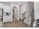 Spacious foyer with wood flooring, white walls, and a staircase with dark wood railing at 151 Outrigger Ln, Troutman, NC 28166