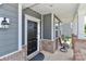 Welcoming covered front porch with brick accents and space for seating to enjoy the outdoors at 151 Outrigger Ln, Troutman, NC 28166