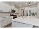 Kitchen features stainless steel appliances, white cabinets, and a large island with sink at 151 Outrigger Ln, Troutman, NC 28166