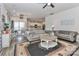 Spacious living room with two grey couches, hardwood floors, and access to dining area at 151 Outrigger Ln, Troutman, NC 28166