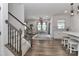 Open-concept living space with wood floors, a dining area, and a partial kitchen view at 151 Outrigger Ln, Troutman, NC 28166