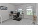This home office includes natural light from two windows, a desk and an office chair at 151 Outrigger Ln, Troutman, NC 28166