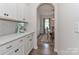 Pantry features white cabinets, light countertop, subway tile backsplash, and KitchenAid stand mixer at 151 Outrigger Ln, Troutman, NC 28166